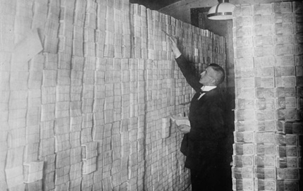 A banker counting huge piles of German money